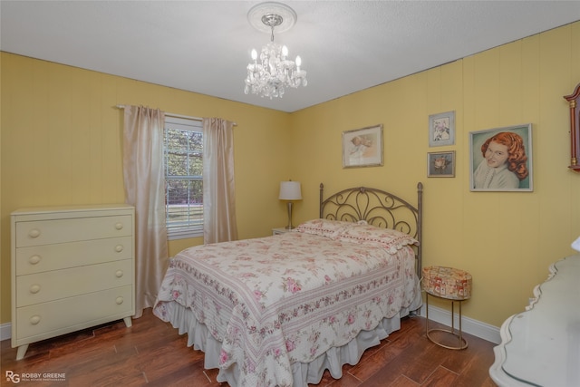 bedroom featuring dark hardwood / wood-style flooring and an inviting chandelier