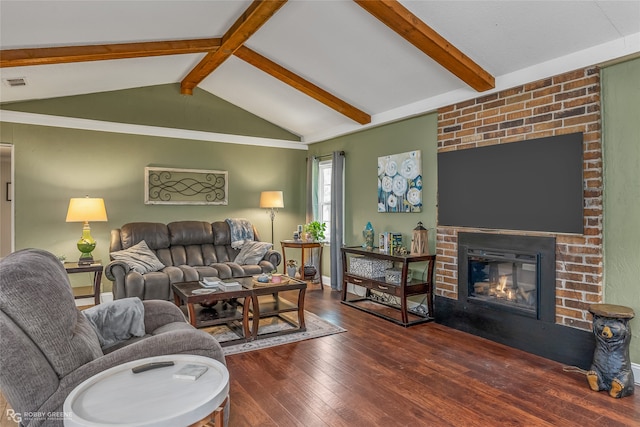 living room with a brick fireplace, dark wood-type flooring, lofted ceiling with beams, and brick wall