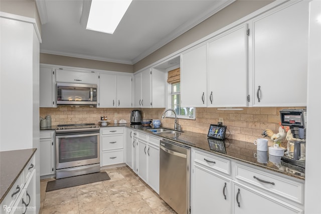 kitchen with light tile patterned flooring, white cabinetry, backsplash, stainless steel appliances, and sink