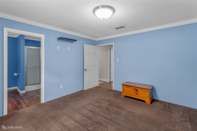 unfurnished bedroom featuring ornamental molding and dark colored carpet