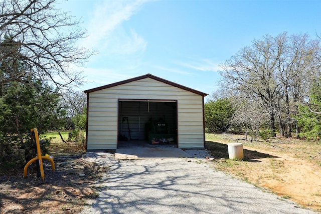 detached garage featuring asphalt driveway