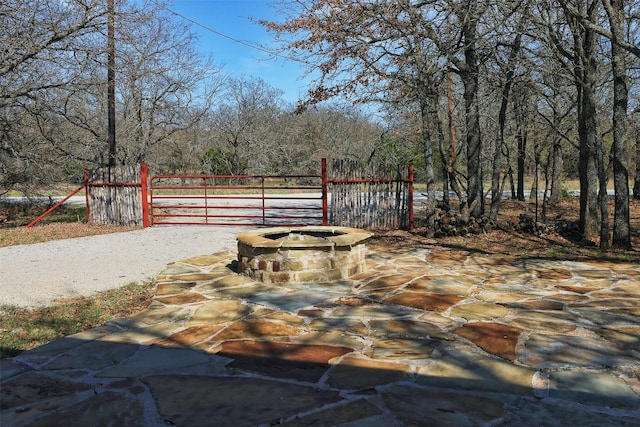 deck featuring fence, an outdoor fire pit, and a gate