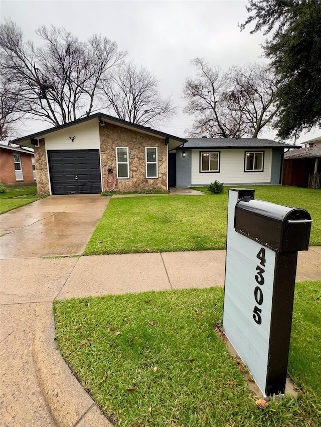 ranch-style home with a garage and a front lawn