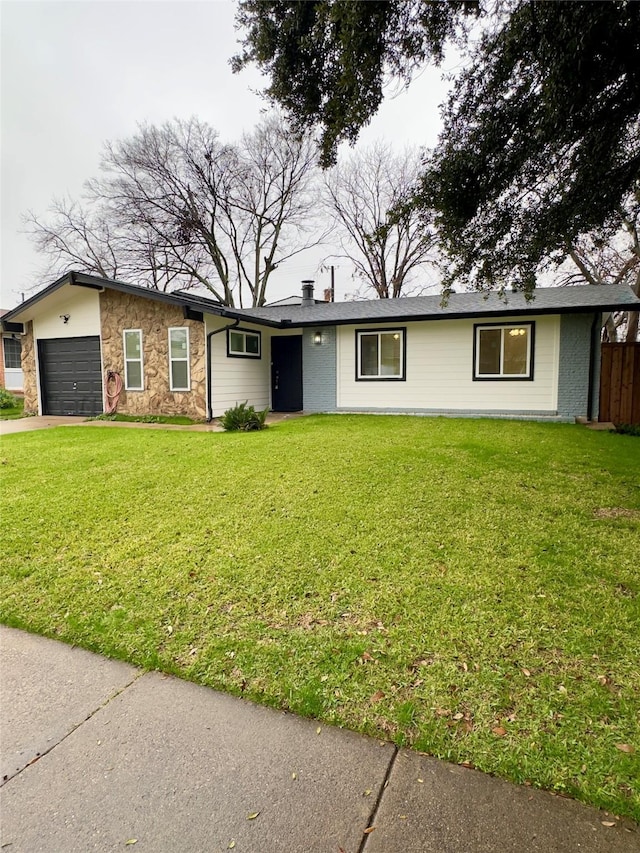 ranch-style home featuring a front yard and a garage