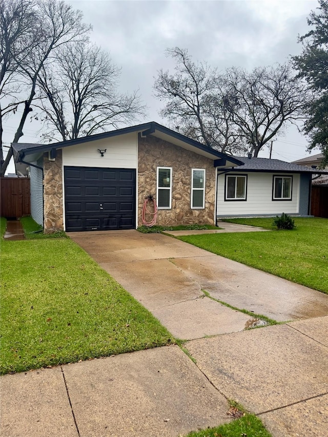 ranch-style home with a front lawn and a garage