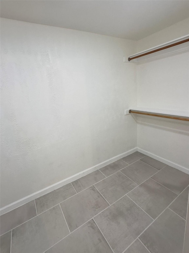 spacious closet with tile patterned flooring