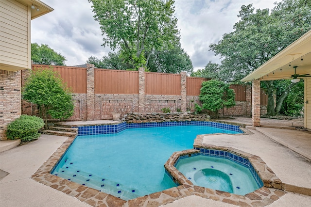 view of swimming pool with a patio area and an in ground hot tub