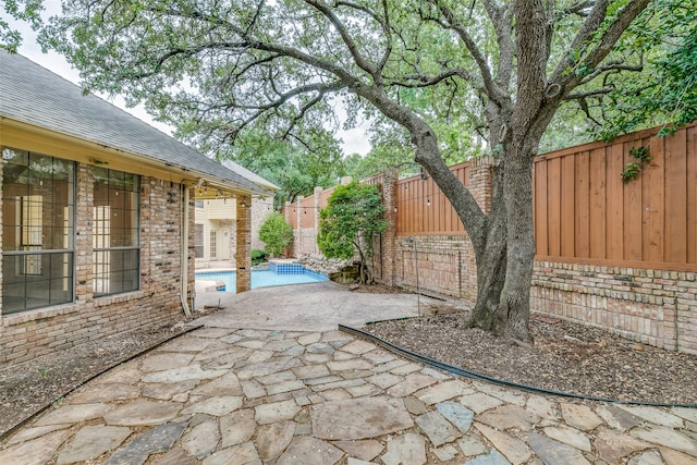 view of patio / terrace with a fenced in pool