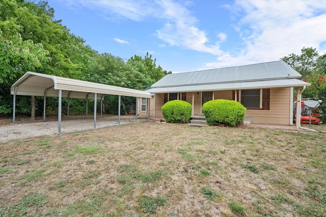 exterior space with a carport, a porch, and a front yard