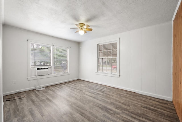 unfurnished room with hardwood / wood-style flooring, a textured ceiling, cooling unit, and ceiling fan