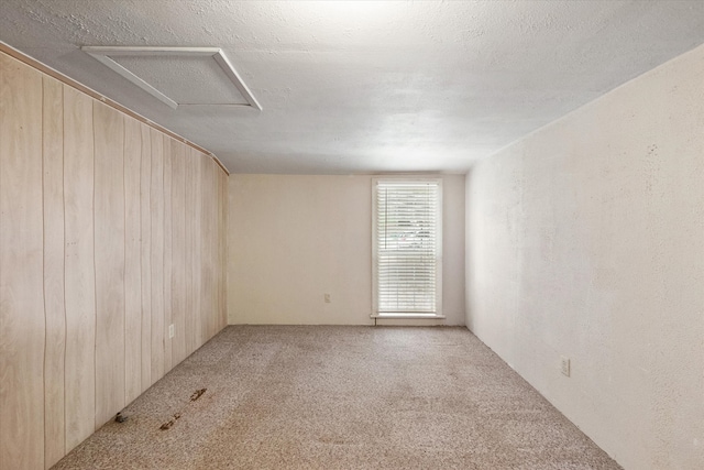 carpeted empty room with a textured ceiling