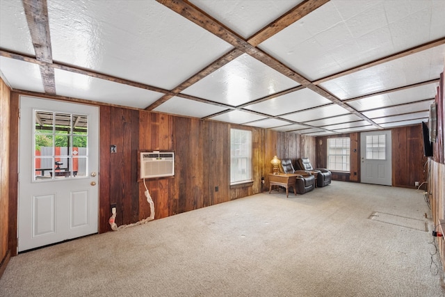 interior space featuring an AC wall unit, carpet, wooden walls, and coffered ceiling