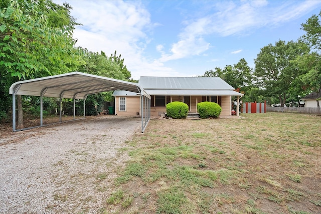 ranch-style home featuring a carport and a front lawn