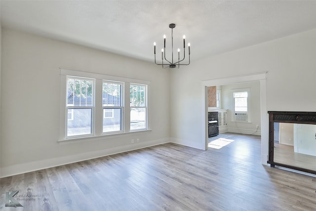 unfurnished living room with plenty of natural light and light hardwood / wood-style flooring