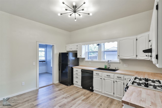 kitchen with white cabinetry, black appliances, light wood-type flooring, sink, and butcher block countertops