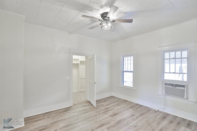 empty room featuring ceiling fan, hardwood / wood-style floors, and cooling unit