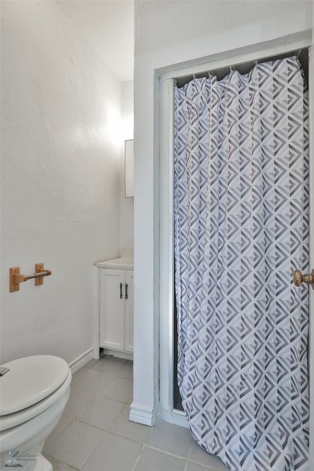 bathroom featuring vanity, toilet, and tile patterned floors