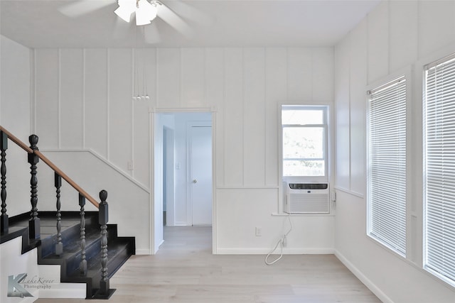 entrance foyer featuring light hardwood / wood-style flooring, ceiling fan, and cooling unit