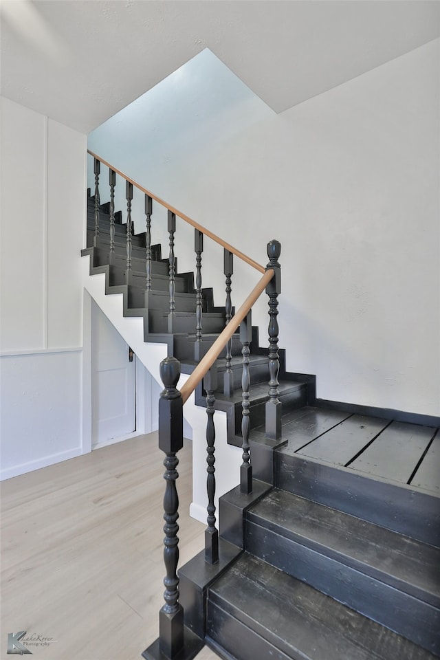 staircase featuring light hardwood / wood-style floors