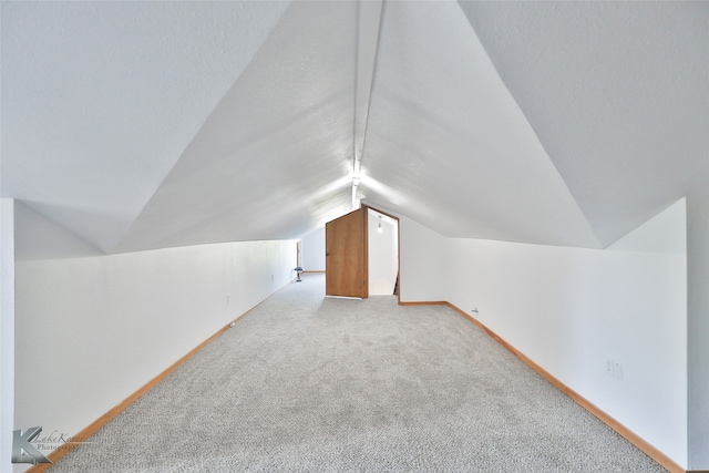 additional living space with carpet floors and lofted ceiling