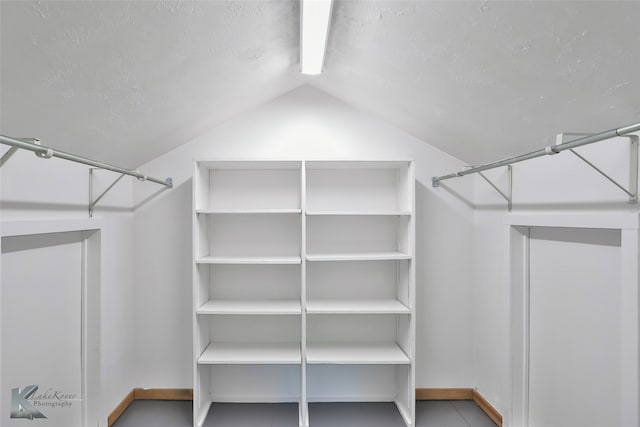 walk in closet with vaulted ceiling