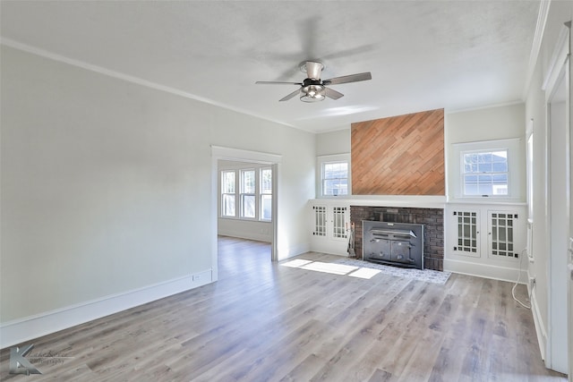 unfurnished living room featuring wood-type flooring, ceiling fan, plenty of natural light, and crown molding