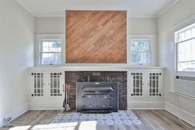 unfurnished living room featuring crown molding and light hardwood / wood-style flooring