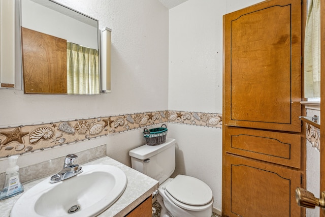 bathroom featuring toilet and vanity