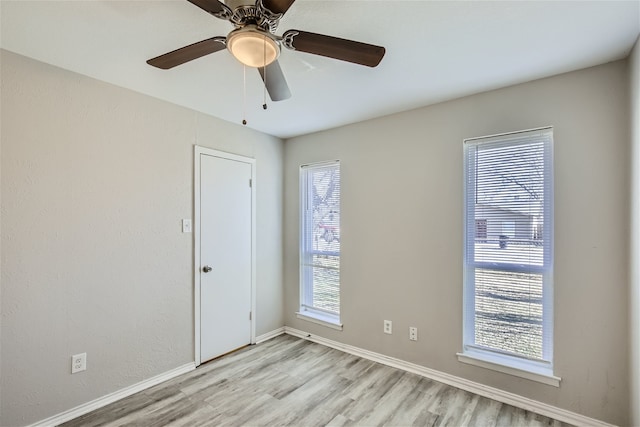 unfurnished room with ceiling fan and light wood-type flooring