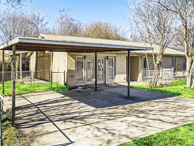 back of property with a carport