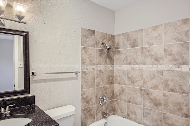 full bathroom featuring vanity, toilet, and tiled shower / bath