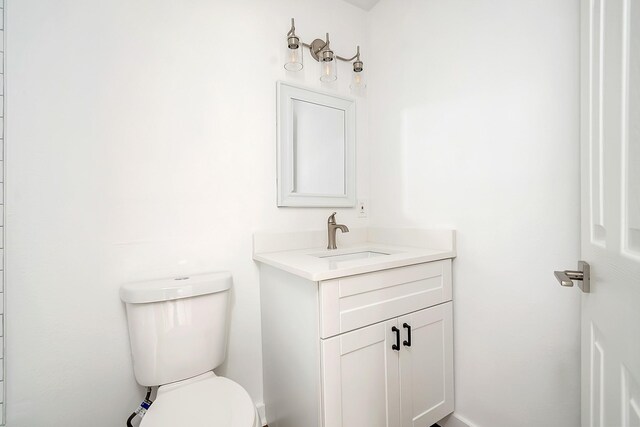 bathroom featuring toilet and vanity