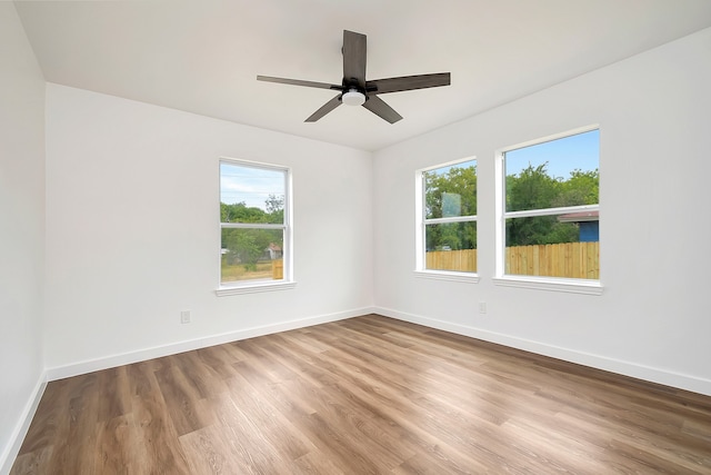 spare room featuring ceiling fan and hardwood / wood-style floors