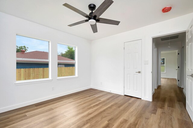 unfurnished bedroom with wood-type flooring and ceiling fan