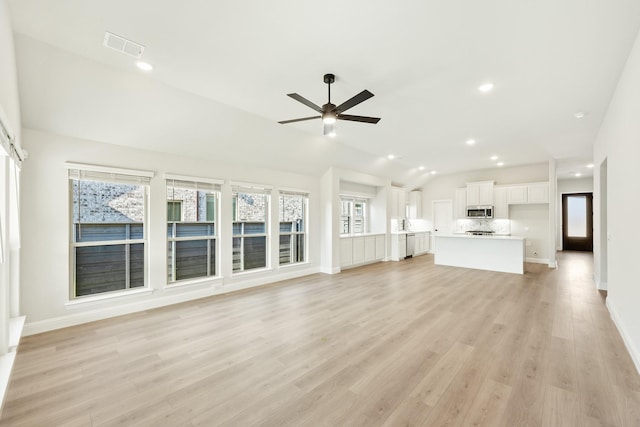 unfurnished living room with ceiling fan, plenty of natural light, light hardwood / wood-style floors, and lofted ceiling