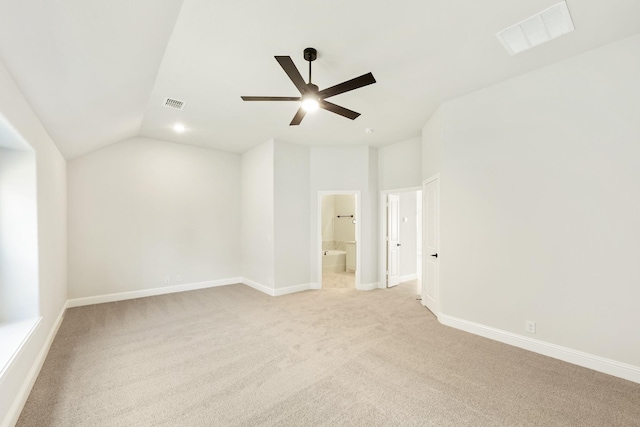 unfurnished room featuring ceiling fan, light colored carpet, and lofted ceiling