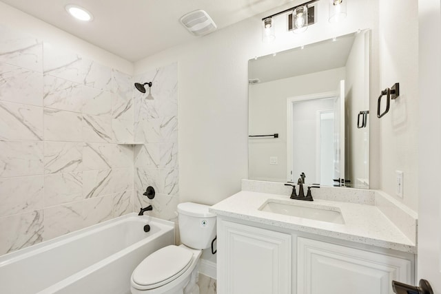 full bathroom featuring vanity, toilet, and tiled shower / bath