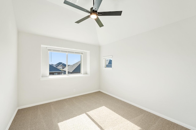 carpeted empty room featuring ceiling fan and lofted ceiling