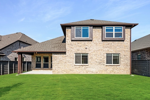 back of house with a yard and a patio