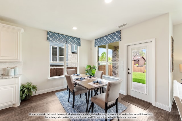 dining area with dark wood-type flooring