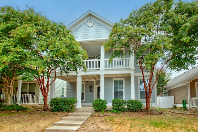 view of front of house featuring a balcony and covered porch