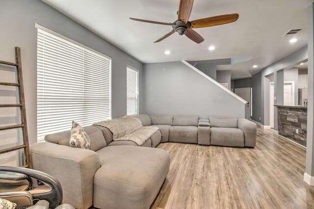 living room featuring light wood-type flooring and ceiling fan