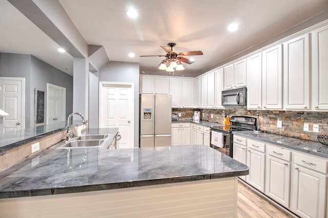 kitchen with ceiling fan, sink, white refrigerator with ice dispenser, range with electric cooktop, and light hardwood / wood-style flooring