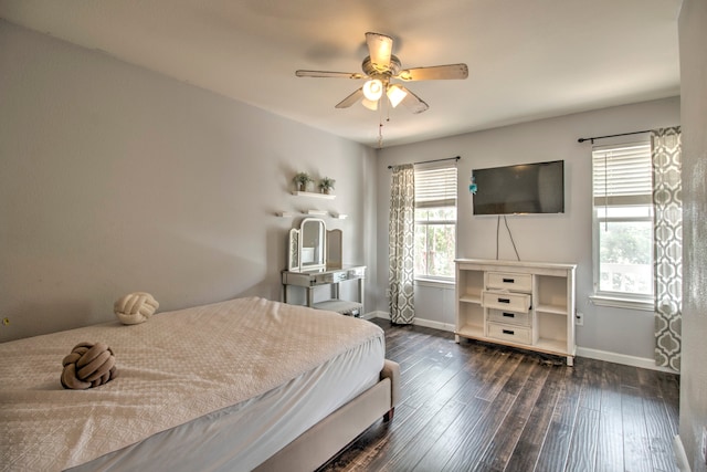 bedroom with dark hardwood / wood-style flooring and ceiling fan