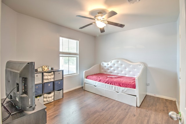 bedroom with hardwood / wood-style floors and ceiling fan