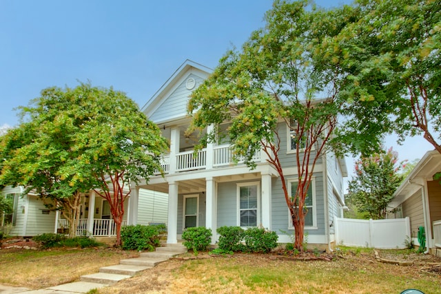 view of front facade with a balcony and covered porch