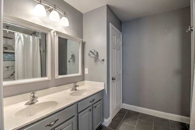 bathroom with dual vanity and tile patterned floors