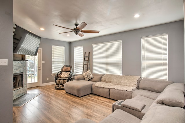 living room with light wood-type flooring and ceiling fan