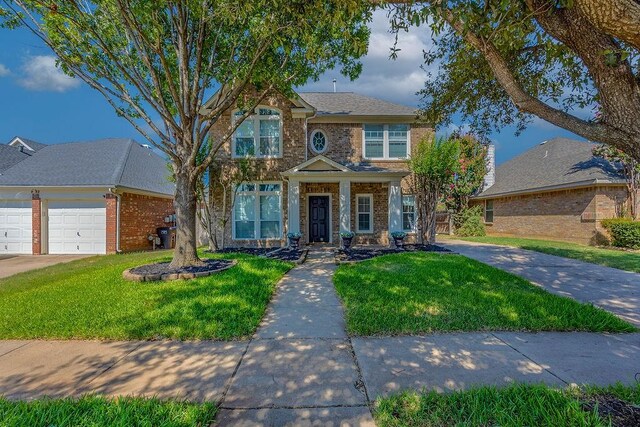 view of front of property featuring a garage and a front lawn