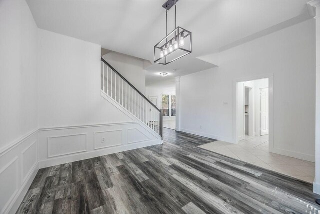 interior space with a notable chandelier and hardwood / wood-style flooring